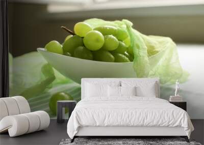 Bowl with sweet grapes on table Wall mural