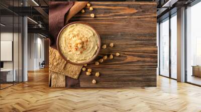 Bowl with tasty hummus on wooden table Wall mural