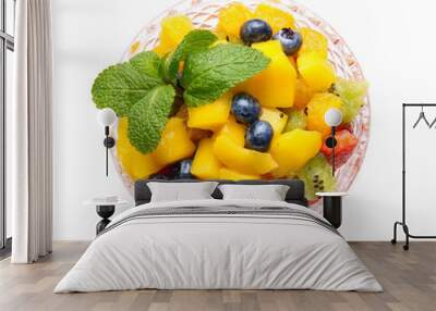 Bowl with tropical fruit salad on white background Wall mural