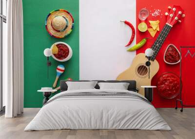 Bowls of tasty salsa sauce and symbols of Mexico on color background Wall mural