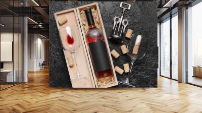 Box with bottle of red wine, glasses, corks and opener on dark background Wall mural