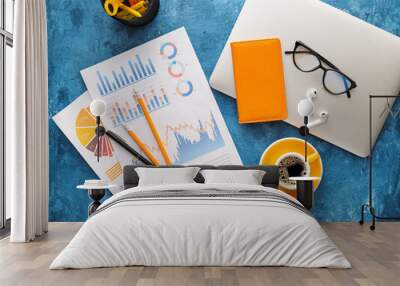 Business charts, gadgets and stationery on blue background Wall mural