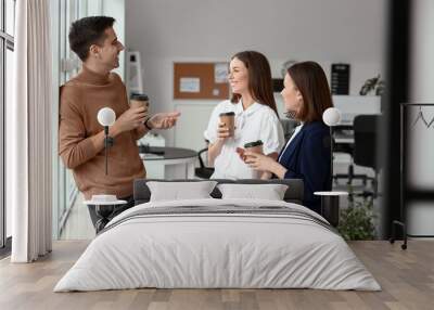 Business colleagues drinking coffee in office Wall mural