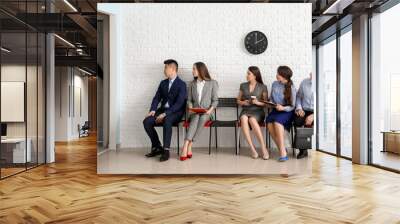 Business people waiting in line indoors Wall mural