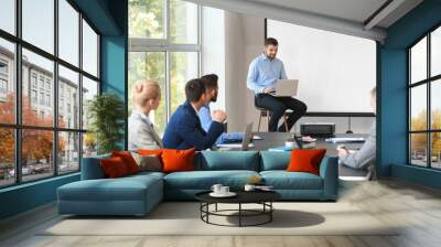 Businessman giving presentation during meeting in office Wall mural