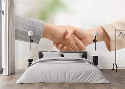 Businesswomen shaking hands during meeting in office Wall mural