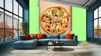 Cardboard box with delicious pizza on green background Wall mural