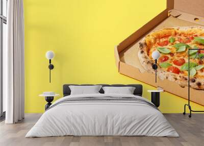 Carton box with tasty pizza Margarita on yellow background Wall mural