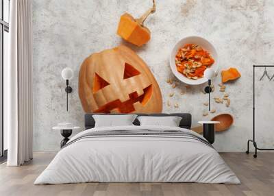 Carved Halloween pumpkin with wooden spoon and seeds on white grunge background Wall mural