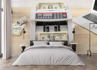 Cash counting machine with dollar banknotes on table in office, closeup Wall mural