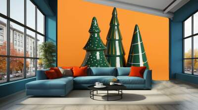 Ceramic Christmas trees on orange background Wall mural