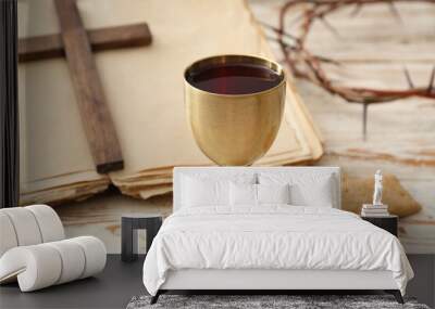 Chalice of wine, bread, Holy Bible and cross on white wooden background Wall mural