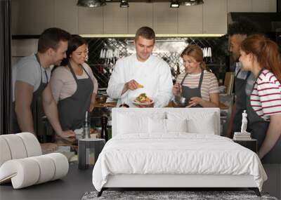 Chef and group of young people during cooking classes Wall mural