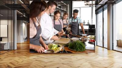 Chef and group of young people during cooking classes Wall mural