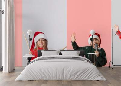 Children with headphones, drumsticks, radio receiver and microphone on color background. Christmas celebration Wall mural