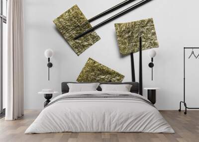 Chopsticks with nori sheets on white background Wall mural