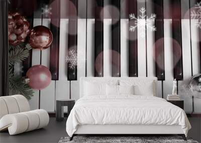 Christmas balls, jingle bells and fir branches on piano keys, top view Wall mural