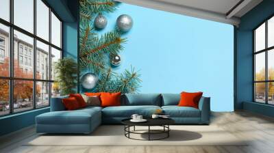 Christmas composition with balls and fir branches on blue background Wall mural