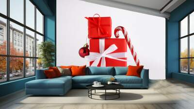 Christmas gift boxes with ball and candy cane toy on white background Wall mural