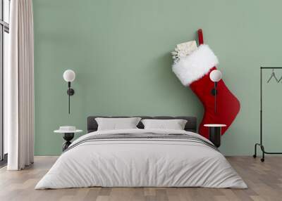 Christmas sock with gift hanging on color wall Wall mural