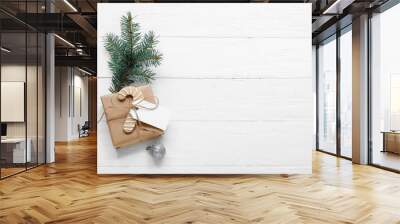 Christmas tree branch with gift box and cookie on white wooden background Wall mural