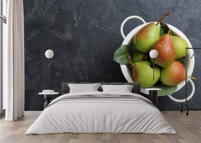 Colander with ripe pears on black table, closeup Wall mural