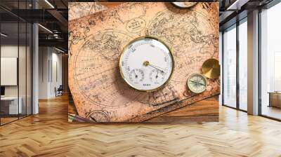 Composition with aneroid barometer and compass on world map. Sailing concept Wall mural