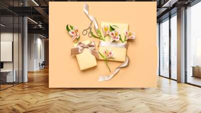 Composition with beautiful gift boxes, alstroemeria flowers and scissors on color background. Women's Day celebration Wall mural