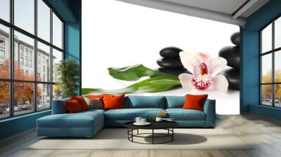 Composition with flower, tropical leaves and spa stones on white background Wall mural