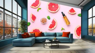 Composition with grapefruit essential oil on color background Wall mural