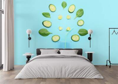 composition with green vegetables and empty glass on blue background Wall mural