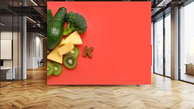 Composition with healthy products containing vitamin K on red background with space for text Wall mural