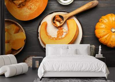 Composition with ripe cut pumpkin on dark wooden background, closeup Wall mural