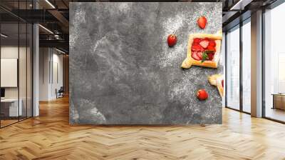 Composition with sweet strawberry puff pastries on grunge background with space for text Wall mural