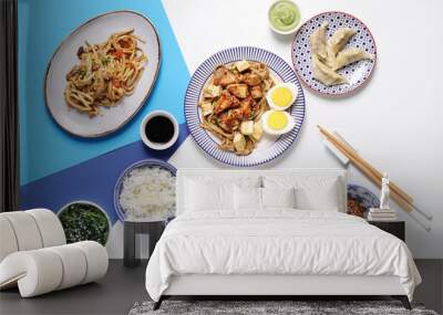 Composition with tasty Chinese dishes and chopsticks on light background Wall mural