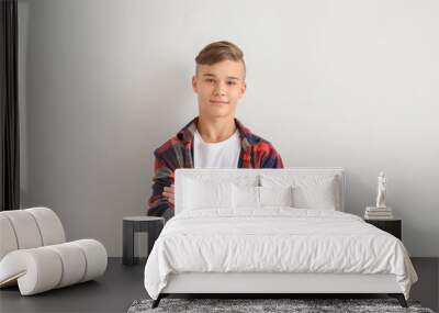 Confident teenage boy on white background Wall mural