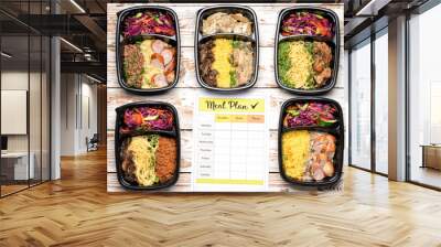 Containers with healthy food and meal plan on wooden background Wall mural