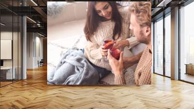 couple drinking delicious mulled wine at home Wall mural