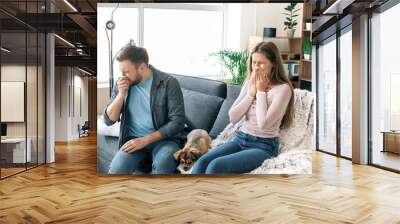 Couple suffering from pet allergy at home Wall mural