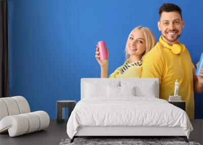 Couple with soda on color background Wall mural