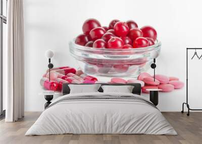 Cranberry pills and bowl of berries on white background Wall mural