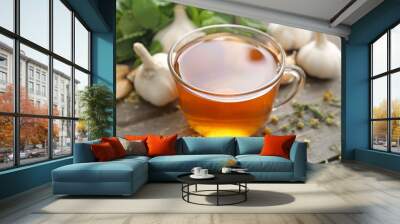 Cup of healthy garlic tea on table Wall mural