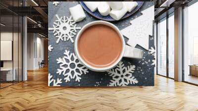 Cup of hot cacao drink with marshmallows and Christmas decorations on dark background Wall mural