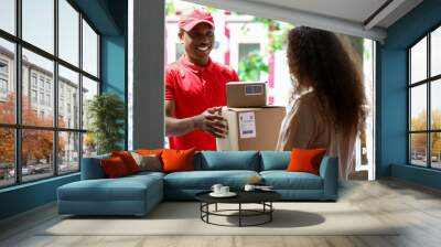 Customer receiving parcel from delivery man Wall mural