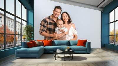 Cute baby with parents on light background Wall mural