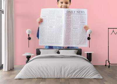 Cute little Asian boy in adult clothes with newspaper on pink background Wall mural