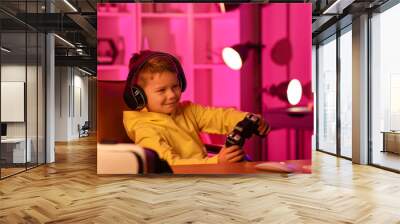 Cute little blogger playing video game at home Wall mural