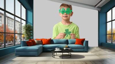 Cute little boy in decorative glasses with clover on grey background. St. Patrick's Day celebration Wall mural