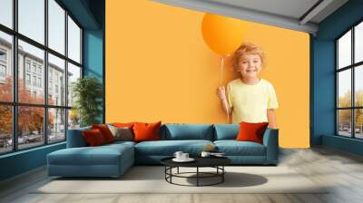 Cute little boy with air balloon on color background Wall mural