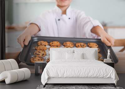 Cute little chef with cookies in kitchen Wall mural